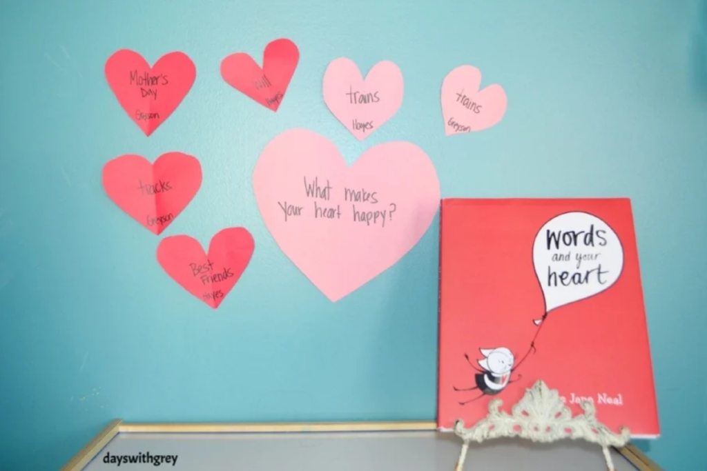 Image of hearts taped to a wall that a preschooler thought of ideas that make their heart happy.