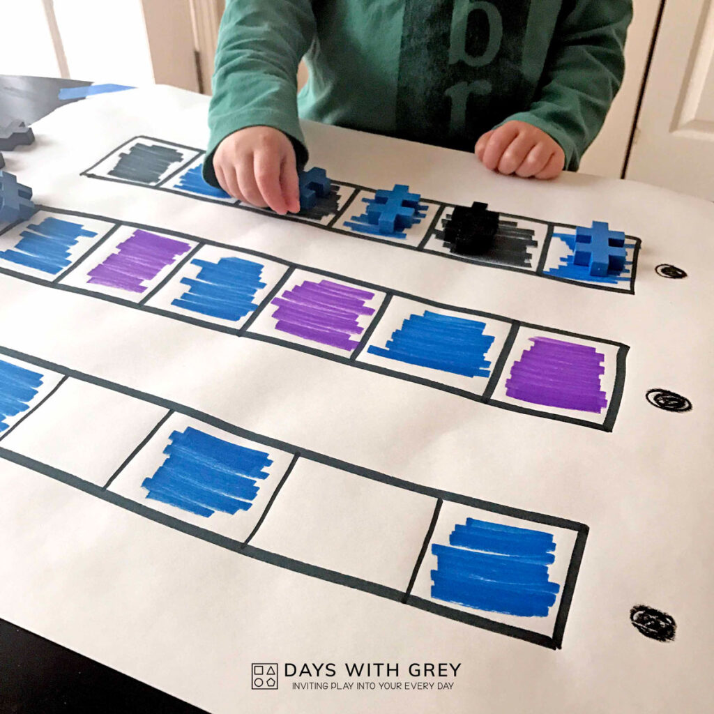 A big white paper on a table with horizontal rows and colored in AB pattern.