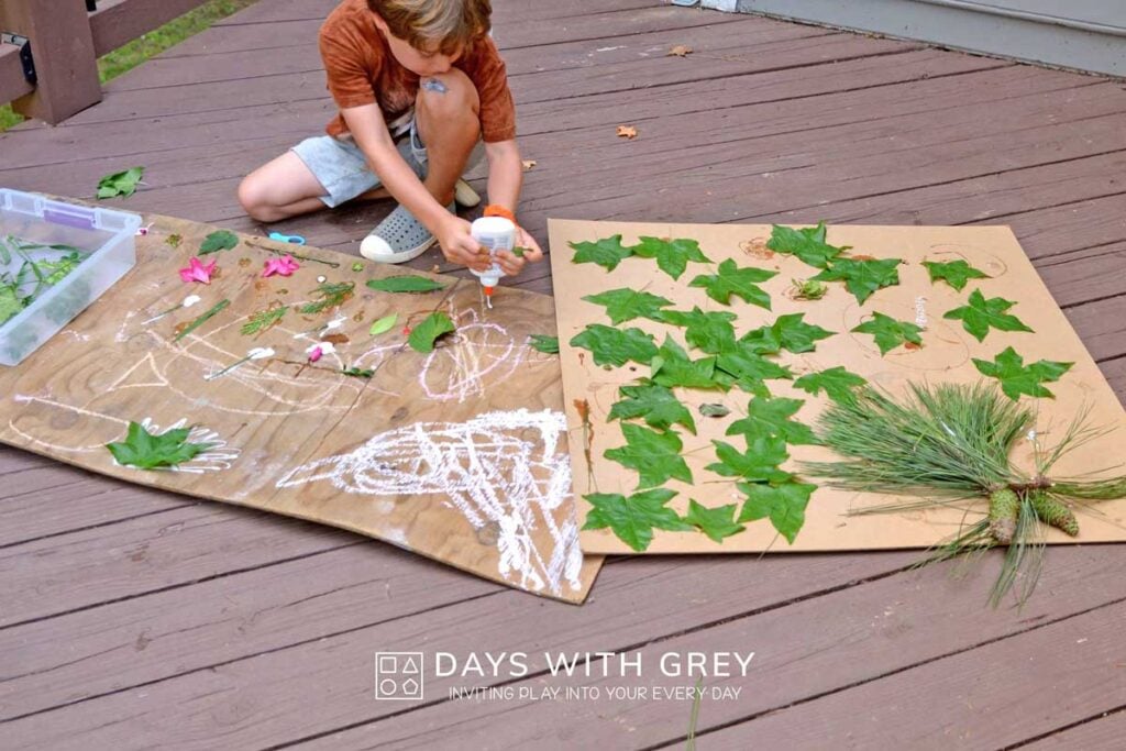 Young boy using liquid glue on two large boards to add nature.