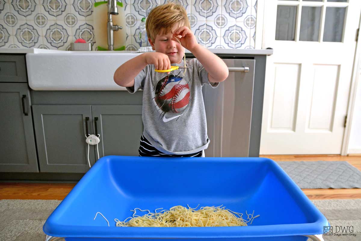 Spaghetti Cutting Bin - Scissor Skills Activity - Busy Toddler