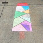 Completed popsicle chalk mosaic on the driveway.