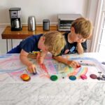 Two boys using their DIY crayons that they made by melting wax in silicone trays.