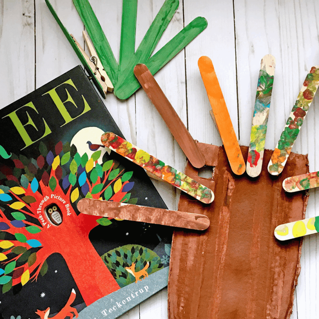 A painted tree and painted craft sticks painted to represent the different seasons.