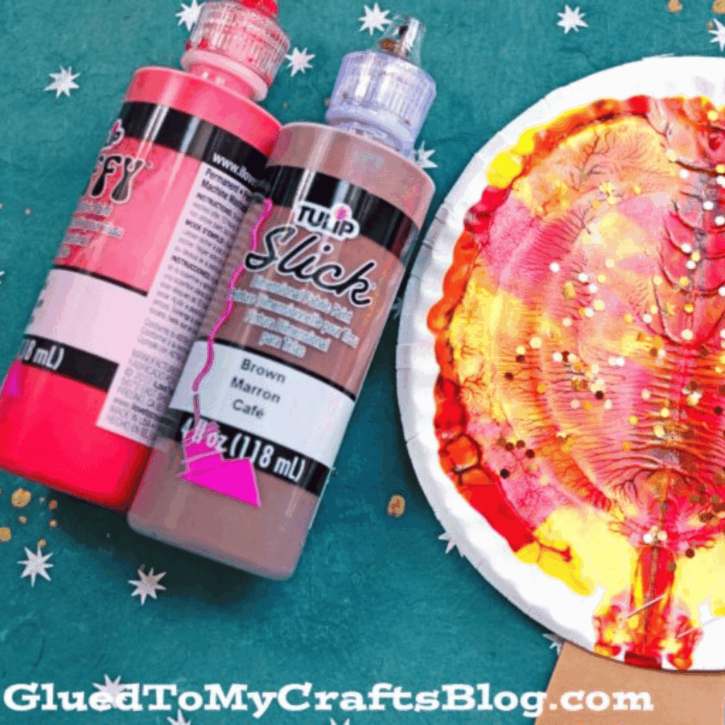 Splatter paint craft to make a fall tree with paper plates and paint.