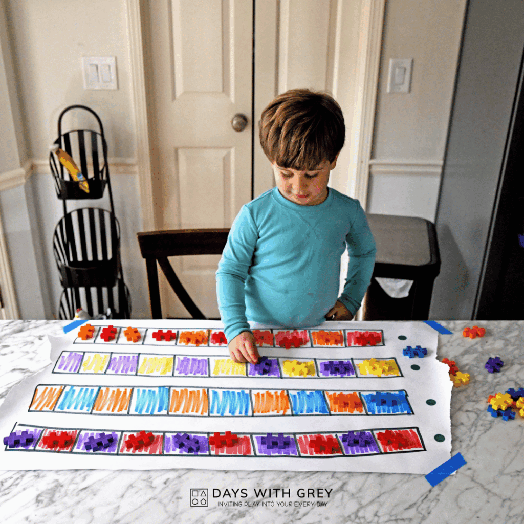 A kindergartener making patters on the table with Plus Plus.