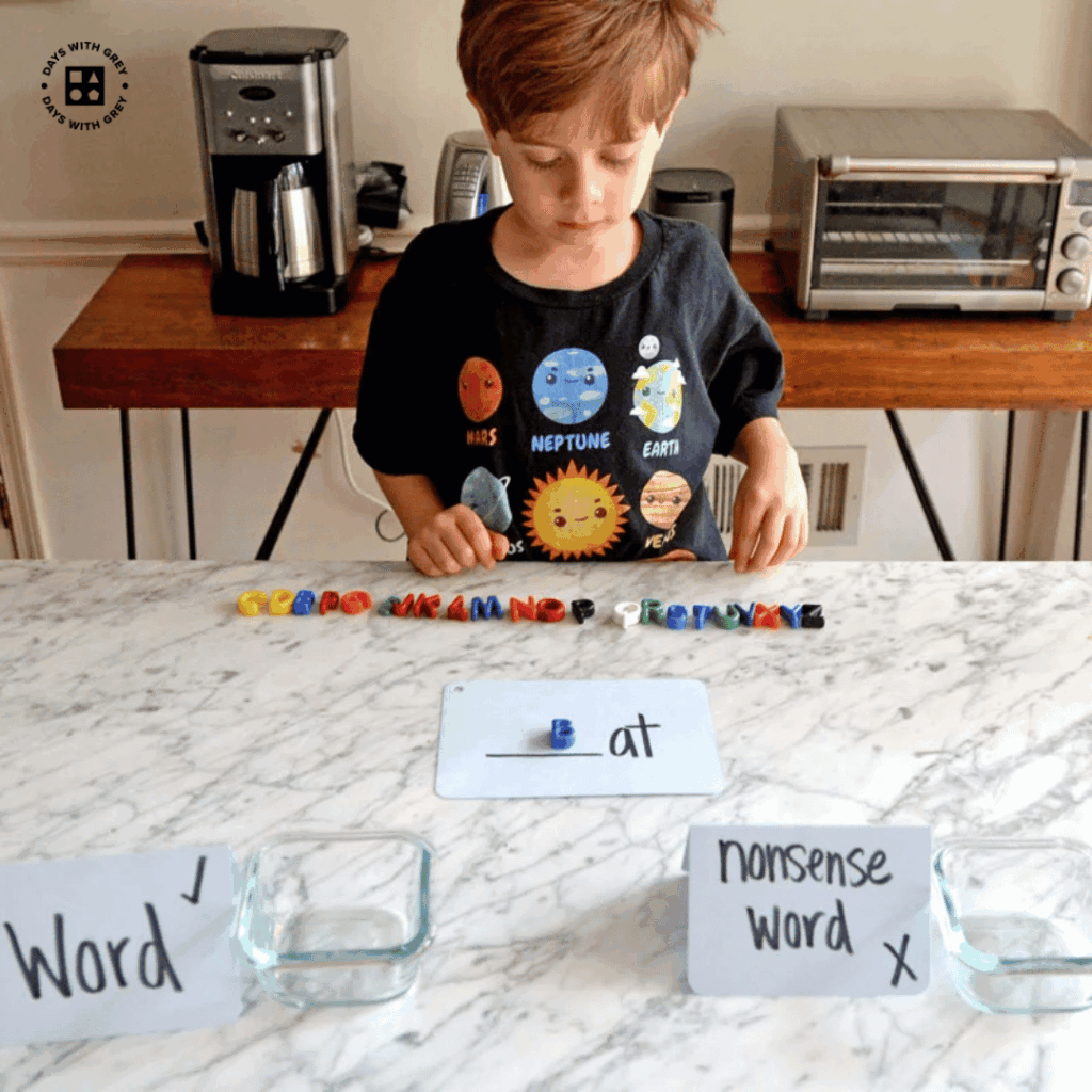 A six year old making words out of small plastic letters.