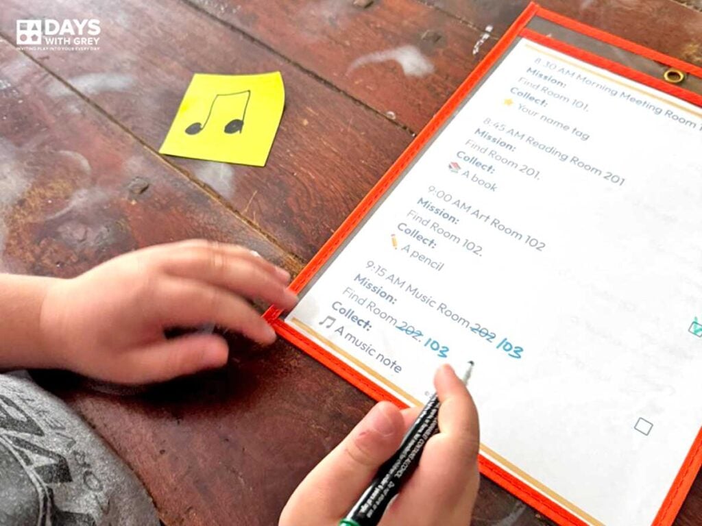 A young child using a checklist that pretends to be a school schedule around the house. Here, he is looking for the music room that is labeled in the house and he is checking it off his schedule.